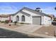A well-kept single-story home featuring a two-car garage, arched windows, and desert landscaping at 1881 E Kerby Farms Rd, Chandler, AZ 85249