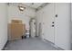 A clean, well-lit two-car garage space featuring water heater and additional storage at 1881 E Kerby Farms Rd, Chandler, AZ 85249