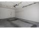 Clean and bright two-car garage space featuring water stains and additional storage at 1881 E Kerby Farms Rd, Chandler, AZ 85249