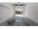 View of the garage's interior with stains on the floor, looking out onto the driveway at 1881 E Kerby Farms Rd, Chandler, AZ 85249