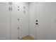 Bright hallway featuring ample storage with white cabinets and a sleek door at 1881 E Kerby Farms Rd, Chandler, AZ 85249