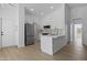 Open-concept kitchen with white cabinets, stainless appliances, and bright, airy design at 1881 E Kerby Farms Rd, Chandler, AZ 85249