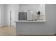 Modern kitchen featuring stainless appliances, white cabinetry, and a marble countertop bar at 1881 E Kerby Farms Rd, Chandler, AZ 85249