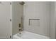 Modern white tiled shower showcasing gold hardware and built-in niche at 1881 E Kerby Farms Rd, Chandler, AZ 85249