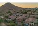 Expansive aerial view of a community featuring lush greenery and mountain views at sunset at 1935 E Seminole Dr, Phoenix, AZ 85022