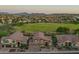 Stunning aerial view of a beautiful neighborhood featuring golf course, scenic mountains, and landscaping at 1935 E Seminole Dr, Phoenix, AZ 85022