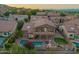 Drone shot of a luxury home featuring a private pool, lounge area, and lush landscaping in a gated community at 1935 E Seminole Dr, Phoenix, AZ 85022