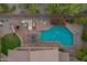 Aerial view captures the backyard oasis with a pool, outdoor kitchen and lush surroundings for relaxation and entertaining at 1935 E Seminole Dr, Phoenix, AZ 85022