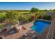 Aerial view of the sparkling pool, patio, outdoor kitchen and golf course view creating a relaxing atmosphere at 1935 E Seminole Dr, Phoenix, AZ 85022