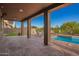 Inviting covered patio features a brick floor and pool access, perfect for outdoor relaxation and entertaining at 1935 E Seminole Dr, Phoenix, AZ 85022