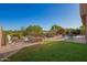 Spacious backyard offers an outdoor kitchen and green grass with well-kept landscaping and neighborhood views at 1935 E Seminole Dr, Phoenix, AZ 85022