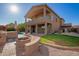 Large backyard with a brick patio, outdoor kitchen, fire pit, pool and lush landscaping at 1935 E Seminole Dr, Phoenix, AZ 85022