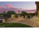 A beautiful backyard setup with a built-in grill, lounge chairs, and a relaxing pool with lush landscaping at 1935 E Seminole Dr, Phoenix, AZ 85022