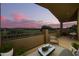 Relaxing balcony with outdoor seating and stunning golf course views at sunset at 1935 E Seminole Dr, Phoenix, AZ 85022