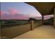A covered balcony offers scenic views of the golf course and surrounding landscape at sunset at 1935 E Seminole Dr, Phoenix, AZ 85022