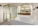 Bathroom showcasing separate shower and soaking tub with gold hardware and bright tile flooring at 1935 E Seminole Dr, Phoenix, AZ 85022