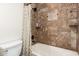 Cozy full bathroom showcasing stylish tiled shower and tub with shower curtain at 1935 E Seminole Dr, Phoenix, AZ 85022