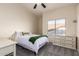 Comfortable bedroom with a large window offering plenty of natural light and a ceiling fan at 1935 E Seminole Dr, Phoenix, AZ 85022