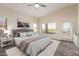 Bright bedroom featuring vaulted ceilings, large windows, and a cozy, neutral-toned decor with carpet at 1935 E Seminole Dr, Phoenix, AZ 85022