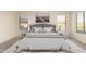 Cozy bedroom with neutral tones featuring coordinated décor, two windows and bedside tables at 1935 E Seminole Dr, Phoenix, AZ 85022