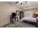 Cozy bedroom with a ceiling fan, a bookcase and a window with plantation shutters at 1935 E Seminole Dr, Phoenix, AZ 85022