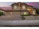 Attractive two-story home features a three-car garage and desert landscaping, set against a colorful sunset backdrop at 1935 E Seminole Dr, Phoenix, AZ 85022