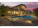 The backyard features a private pool, and a covered patio with a second-story balcony, perfect for relaxation at 1935 E Seminole Dr, Phoenix, AZ 85022