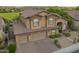 Attractive home featuring a three-car garage, tile roof, desert landscaping, and covered front porch at 1935 E Seminole Dr, Phoenix, AZ 85022