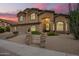 Elegant two-story home with a three-car garage and desert landscaping, illuminated by a vibrant sunset sky at 1935 E Seminole Dr, Phoenix, AZ 85022