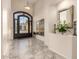 Bright foyer with tile flooring, high ceilings, decorative mirror, and an ornate iron door at 1935 E Seminole Dr, Phoenix, AZ 85022