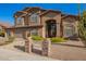 Inviting two-story home features a decorative front door, manicured landscaping, and a three-car garage at 1935 E Seminole Dr, Phoenix, AZ 85022