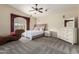 Spacious primary bedroom with a ceiling fan, large windows, and neutral colors at 1935 E Seminole Dr, Phoenix, AZ 85022