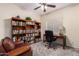 Well-lit home office with bookshelves, desk, and comfortable seating area at 1935 E Seminole Dr, Phoenix, AZ 85022