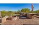 Outdoor kitchen equipped with a built-in grill, brick fire pit and ample counter space for entertaining at 1935 E Seminole Dr, Phoenix, AZ 85022