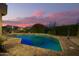 Relaxing backyard with a sparkling pool, brick patio, and desert landscaping, perfect for enjoying warm evenings at 1935 E Seminole Dr, Phoenix, AZ 85022
