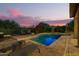 Backyard pool features a brick surround, beautiful plantings, and comfortable lounge seating at 1935 E Seminole Dr, Phoenix, AZ 85022