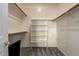 Spacious walk-in closet with wood rods and shelving for organized storage at 1935 E Seminole Dr, Phoenix, AZ 85022