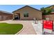 The backyard offers a mix of gravel, artificial turf, and comfortable seating options at 226 E Monza Way, San Tan Valley, AZ 85140