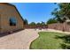 Inviting backyard with gravel landscaping, artificial turf, and cozy fire pit area for outdoor relaxation at 226 E Monza Way, San Tan Valley, AZ 85140