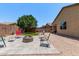 Spacious backyard featuring a fire pit, paved patio, gravel, and a lush green lawn for outdoor enjoyment at 226 E Monza Way, San Tan Valley, AZ 85140