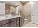 Bathroom with dual sinks, framed mirror, tile floors, and essential accessibility features at 226 E Monza Way, San Tan Valley, AZ 85140