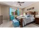 A well-lit bedroom with warm tones, a ceiling fan, and blue accents at 226 E Monza Way, San Tan Valley, AZ 85140