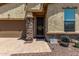 Inviting front entry with a security screen door, stone accents, and charming desert-themed decor at 226 E Monza Way, San Tan Valley, AZ 85140