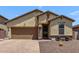 Charming single-story home with desert landscaping, a two-car garage, and covered entryway at 226 E Monza Way, San Tan Valley, AZ 85140