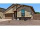 A beautiful single-story home with a brick-accented facade, desert landscaping, and a convenient two-car garage at 226 E Monza Way, San Tan Valley, AZ 85140