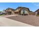 Single-story home with desert landscaping, a brick driveway, and a convenient two-car garage at 226 E Monza Way, San Tan Valley, AZ 85140