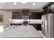 A well-equipped kitchen featuring stainless steel appliances and dark wood cabinetry at 226 E Monza Way, San Tan Valley, AZ 85140