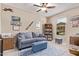 Comfortable living room featuring a sofa, airplane décor, and ample natural light from the large window at 226 E Monza Way, San Tan Valley, AZ 85140