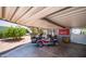 Carport area with a golf cart parked underneath at 2400 E Baseline Ave # 44, Apache Junction, AZ 85119