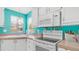 Well-equipped kitchen featuring modern appliances, white cabinets, and a charming design at 2400 E Baseline Ave # 44, Apache Junction, AZ 85119